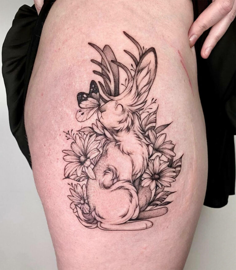 Black and grey jackalope tattoo with butterfly and florals