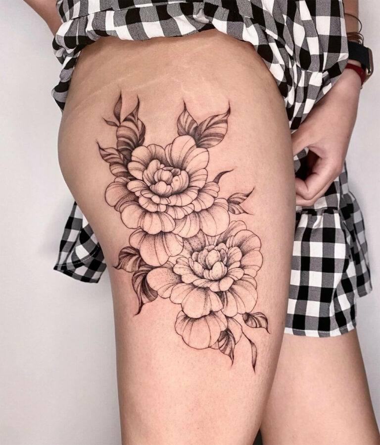 Black and grey illustrative floral tattoo on the thigh