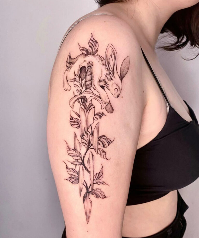Black and grey illustrative rabbit, sword, and leaves tattoo