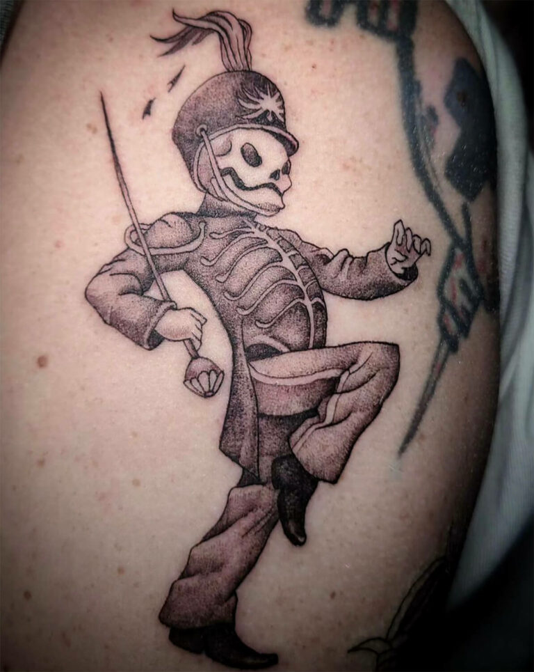 Black and grey tattoo of a skeleton marching band conductor