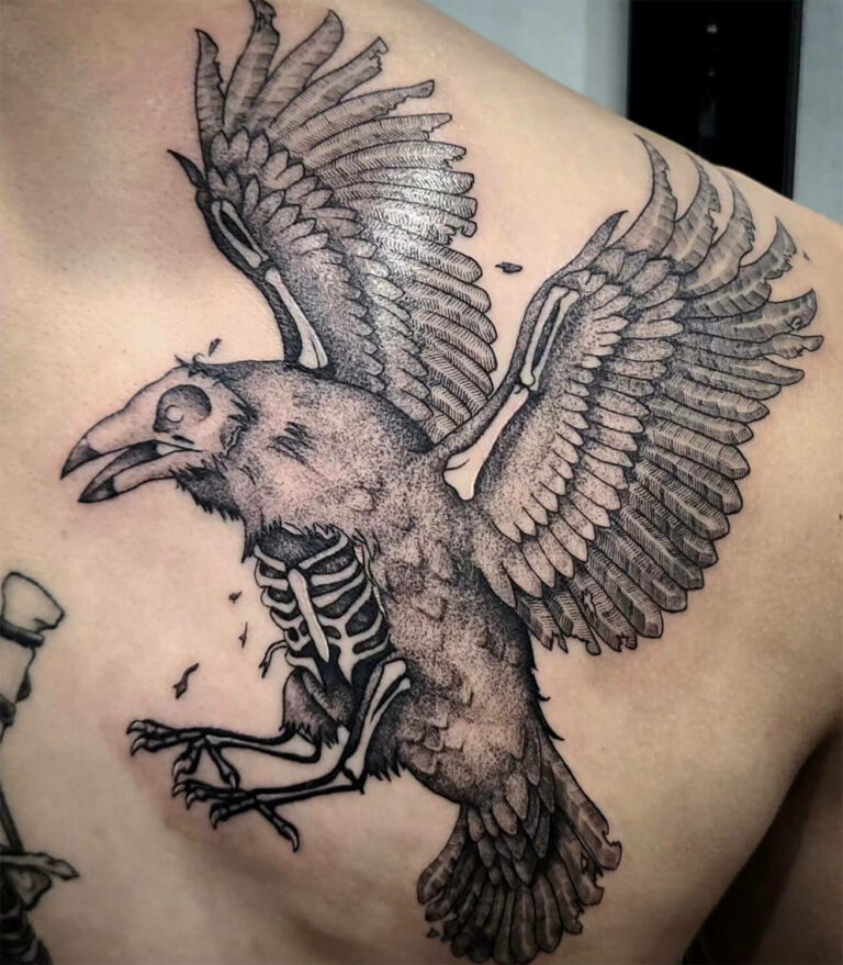 Black and grey tattoo of a decaying crow in flight with ribcage and skull visible