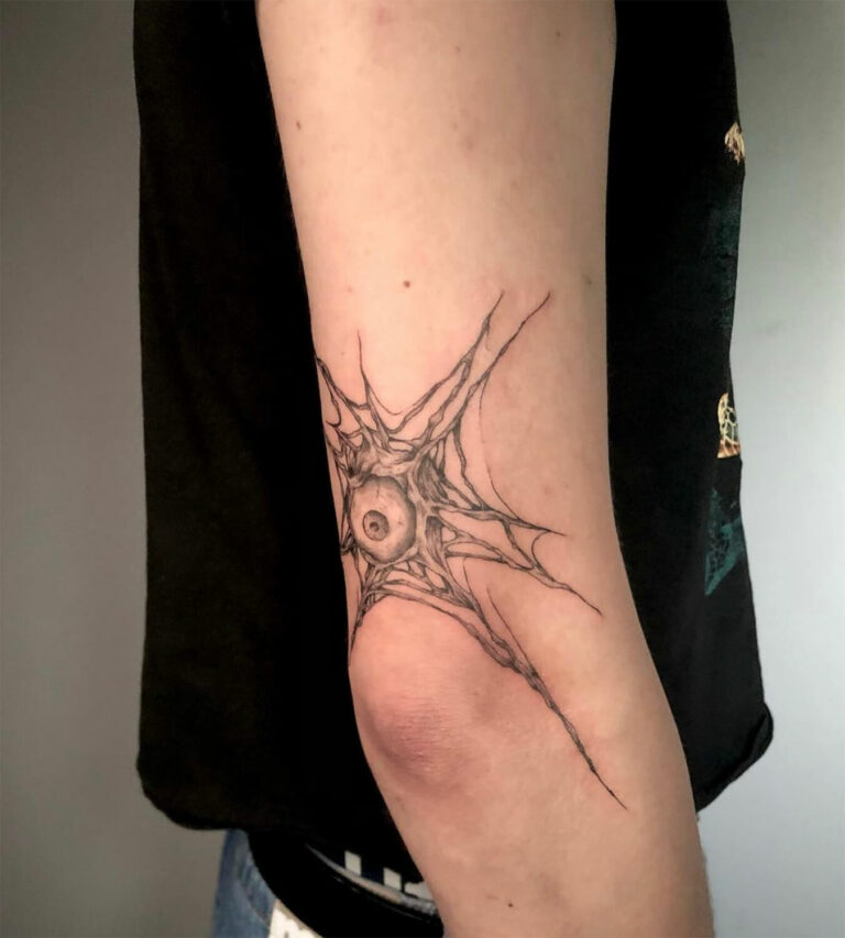 Abstract eye tattoo with radiating angular linework near the elbow by Tanya