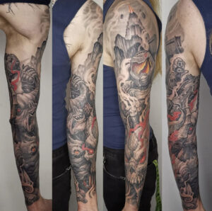 Black/grey Doomed theme horror arm tattoo sleeve with pops of red and orange color