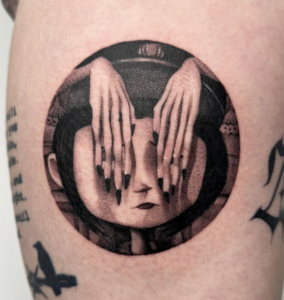 Black/grey tattoo of Coraline with Other Mother's hands covering her eyes