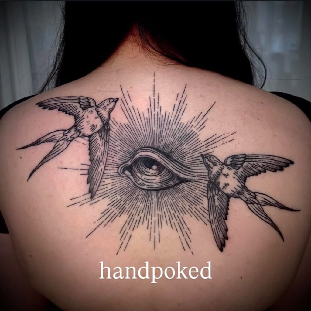 Handpoked all-seeing eye and swallow tattoo on upper back, created by guest artist Chels at Victims of Ink in Melbourne.