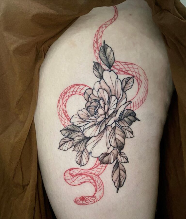 Tattoo on the upper leg of a black and grey peony with a red snake