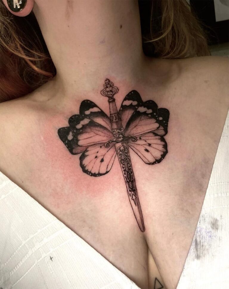 Black and grey chest tattoo of a dagger with abstract butterfly wings