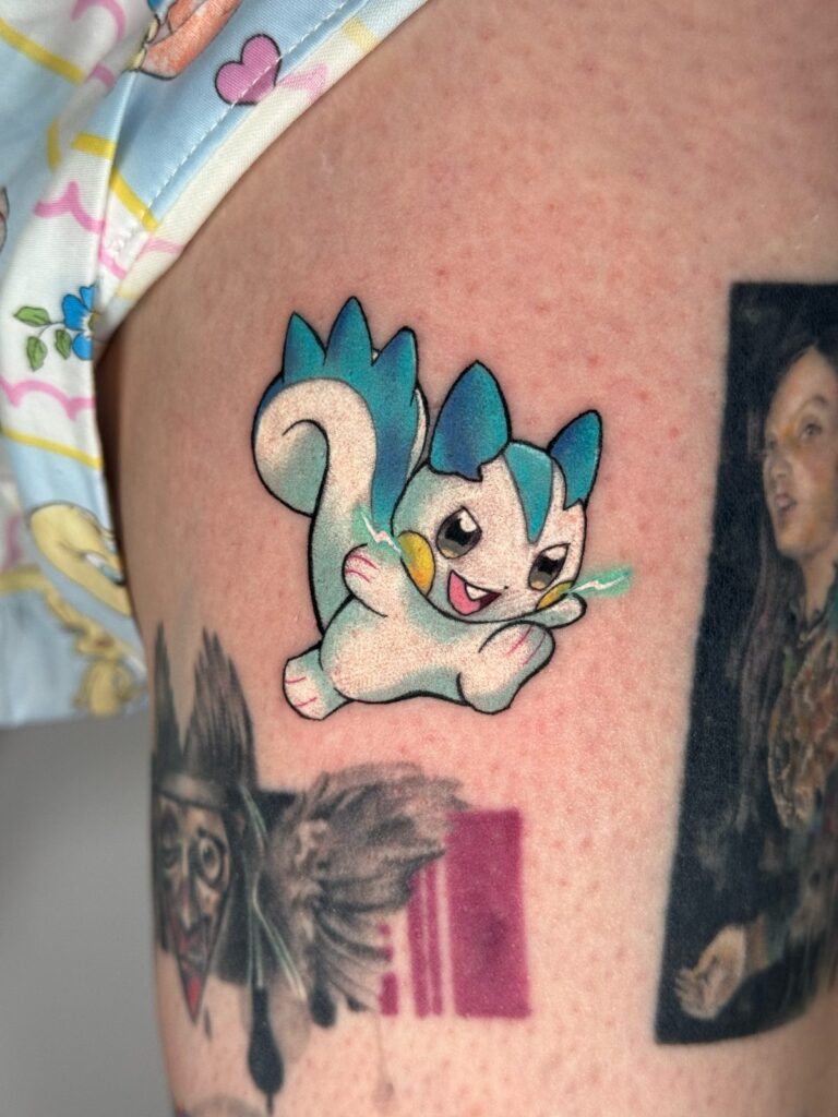 Blue-and-white Pokémon character tattoo by David Carry at Victims of Ink