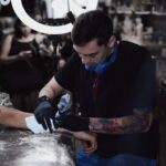 David Carry tattooing a client at Victims of Ink in South Yarra, Melbourne
