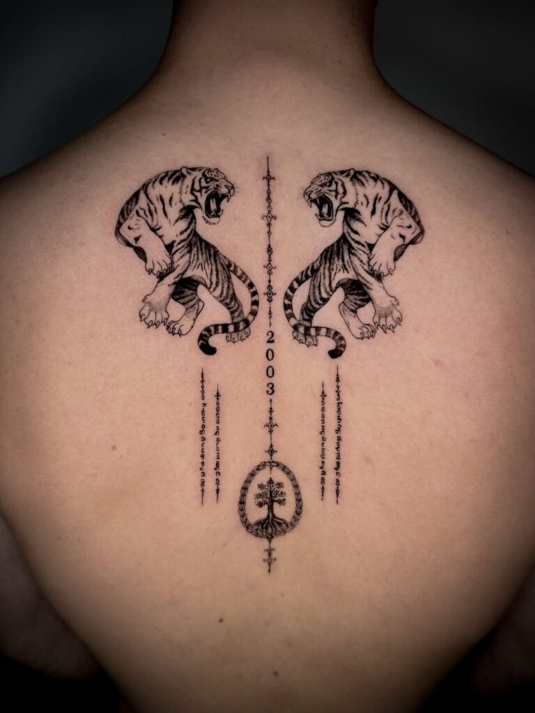 Fine-line tiger pair and symmetrical ornamental details on the upper back by David Carry