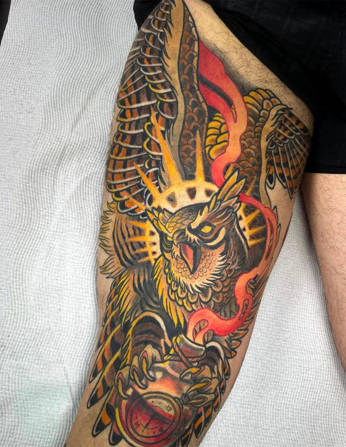 Large-scale neotraditional tattoo of an owl on the back of the thigh