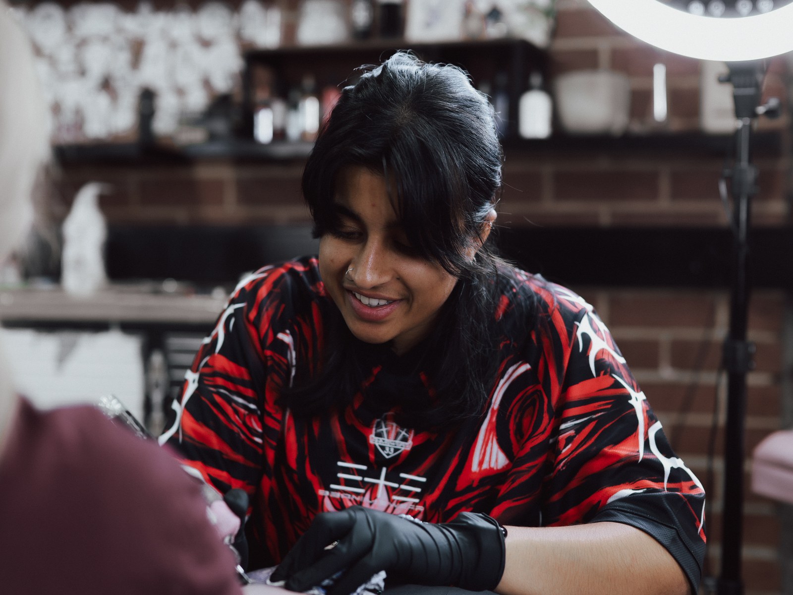 Khash tattooing a client at Victims of Ink in South Yarra