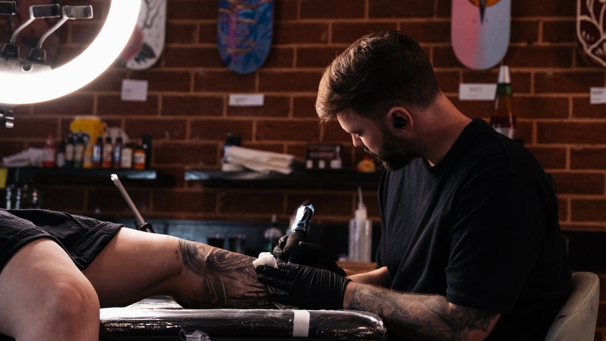 Tobias Meredith working on a tattoo at Victims of Ink in South Yarra