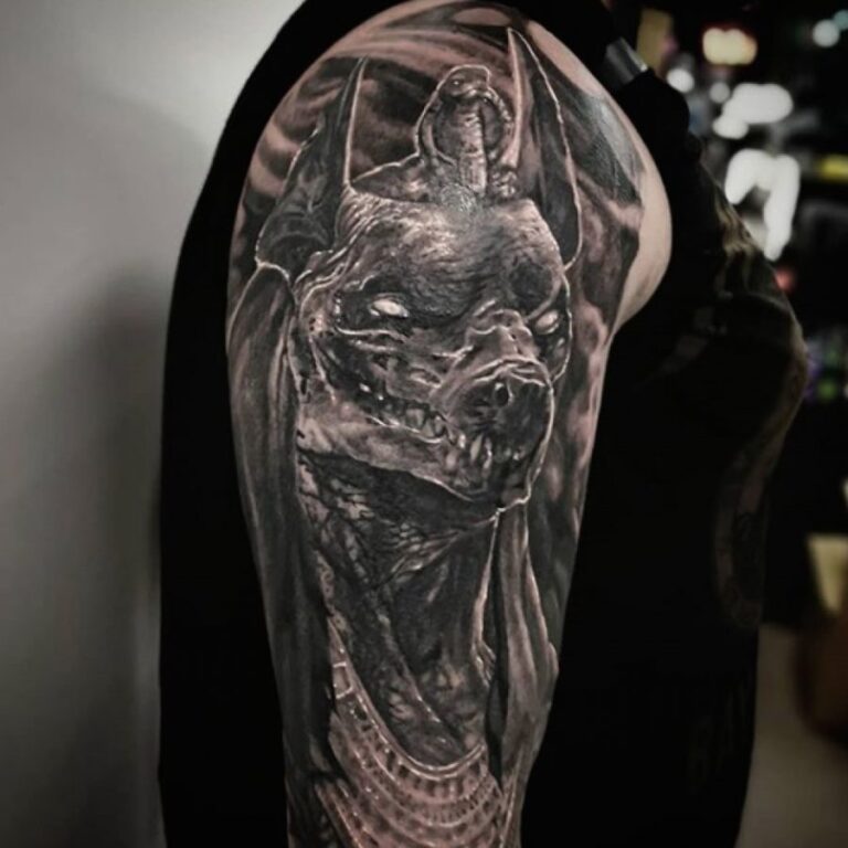 Mythical creature fantasy tattoo on upper arm
