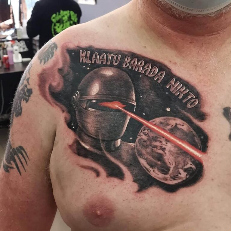 Black/grey realism chest piece depicting Gort from The Day the Earth Stood Still featuring red laser vision