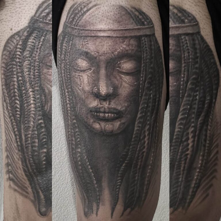 Black and grey Giger-inspired portrait tattoo framed by textured biomechanical forms by Will Halstead-Smith
