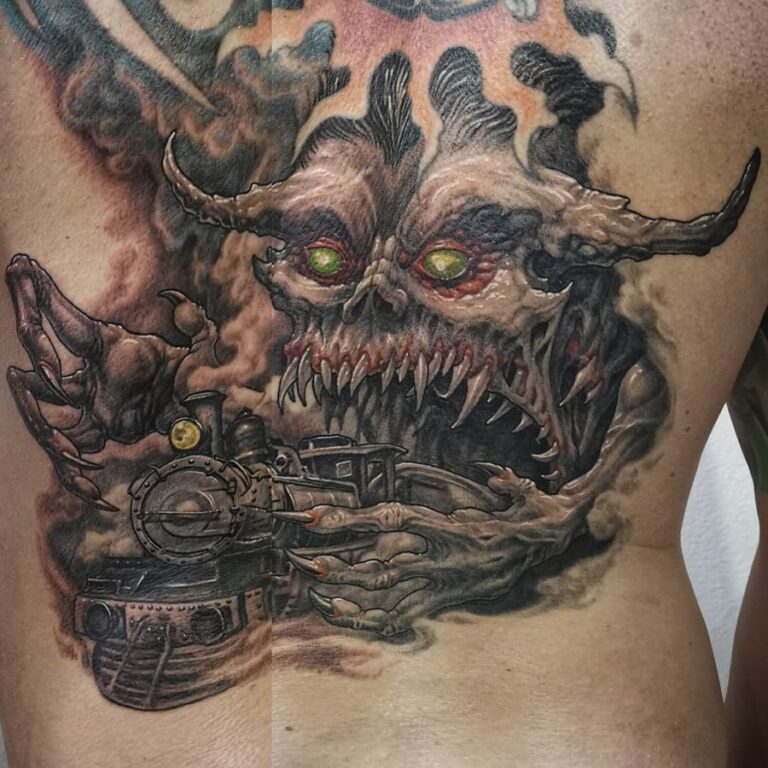 Black/grey horror monster tattoo eating a train