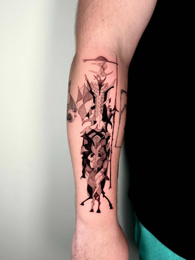 Dark abstract blackwork figure with sharp branching lines on a calf by Woody