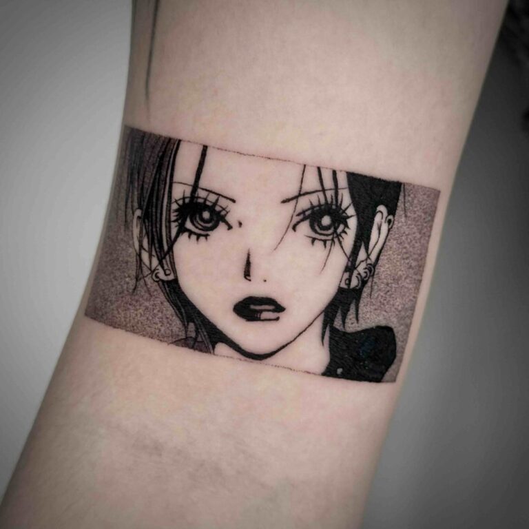 Black and grey manga panel tattoo showing a character’s face by Woody