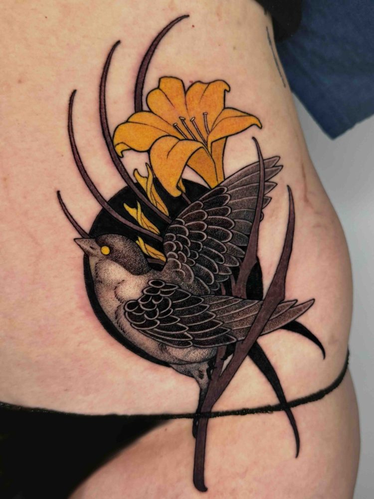 Swallow and yellow flower tattoo with sweeping black lines on the ribs by Woody