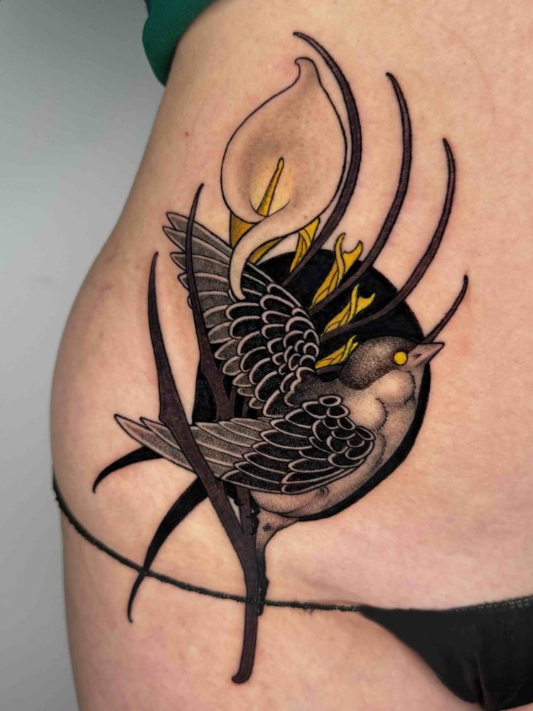 Swallow tattoo with sweeping black lines and yellow accents on the ribs by Woody
