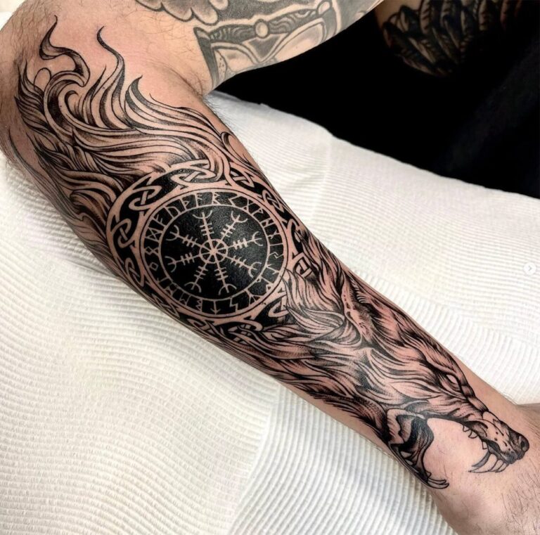 Black and grey lower-leg tattoo of a wolf, circular compass-style symbol and interlaced lines by Yesid