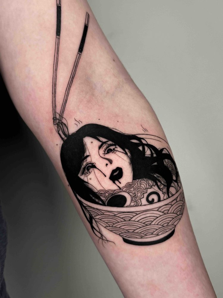 Tattoo of a woman's face in a noodle bowl with chopsticks, black ink, intricate line art.
